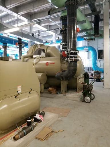 Trane water-cooled centrifugal chiller installed in a mechanical room with front piping